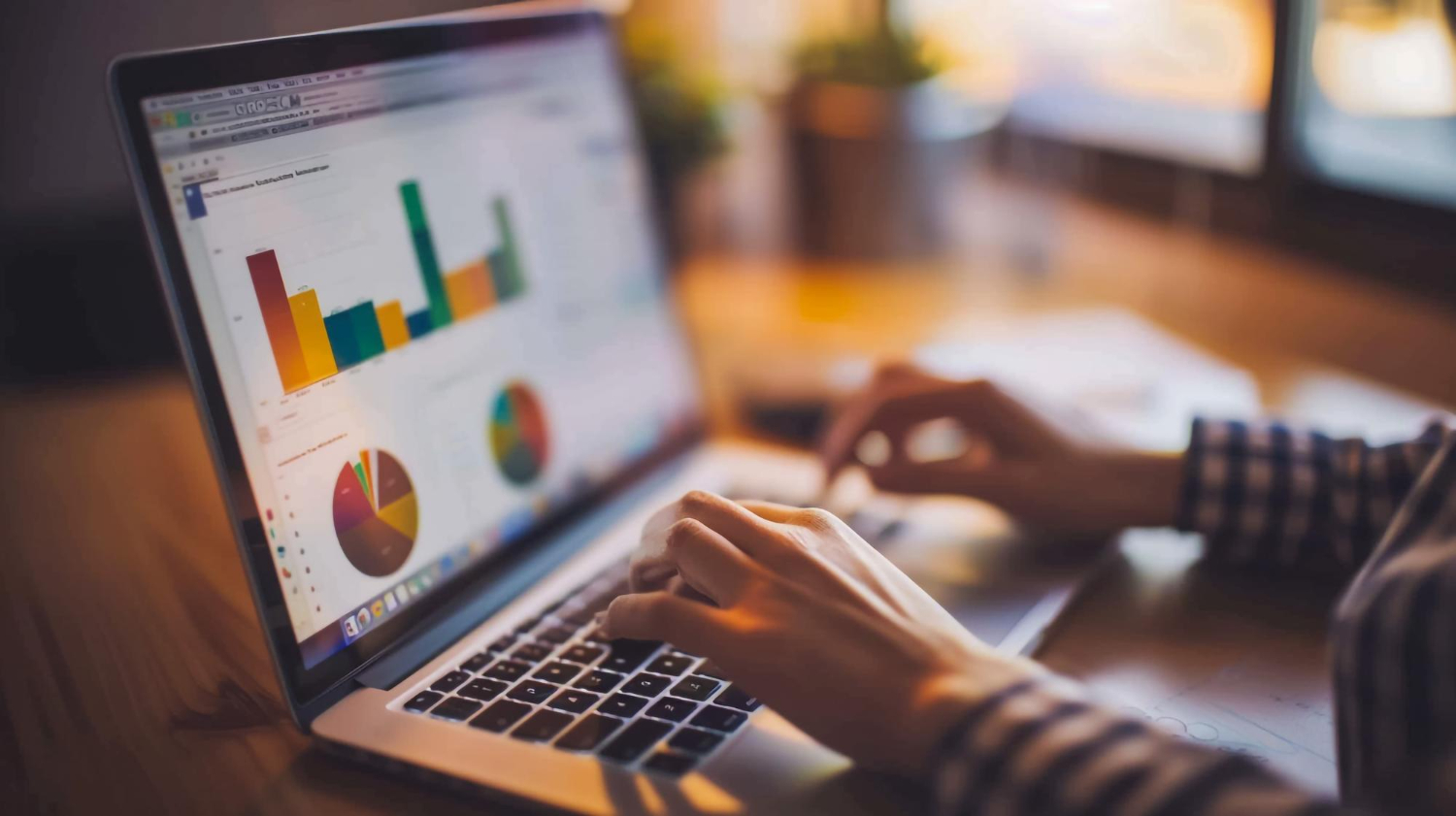 Bar chart comparing bounce rate and exit rate metrics on laptop with spreadsheet